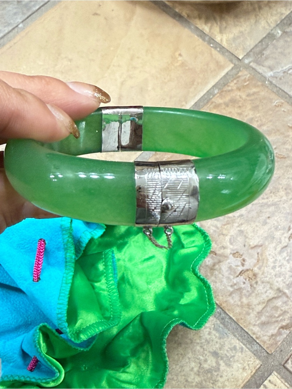 Genuine green jade solid bangle with a .925 sterling silver hinge, safety chain.